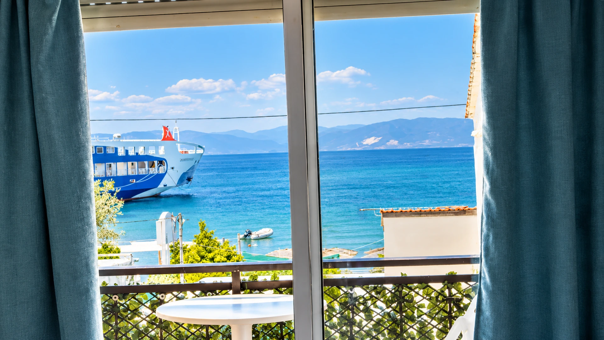 Sea view through the balcony doors in Thassos